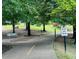 Scenic walking trail with 'Stay On Trail' signage, surrounded by lush greenery, benches, and trees at 211 Colonial Homes Nw Dr # 2508, Atlanta, GA 30309