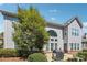 Back exterior showcasing a stone patio and a large tree, perfect for outdoor entertaining at 4240 Hastings Dr, Cumming, GA 30041