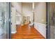 Grand entryway with beautiful hardwood floors, wainscoting, and decorative glass double doors at 4240 Hastings Dr, Cumming, GA 30041