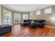 Comfortable living room featuring hardwood floors, crown molding, and large windows at 4240 Hastings Dr, Cumming, GA 30041