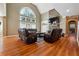 Open living room features a soaring ceiling, large windows, a stone fireplace, and hardwood floors at 4240 Hastings Dr, Cumming, GA 30041