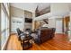 Inviting living room with a stone fireplace, soaring ceiling, hardwood floors, and a staircase at 4240 Hastings Dr, Cumming, GA 30041