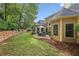Spacious backyard with lush landscaping and a cozy patio area at 378 Rhodes House Dr, Suwanee, GA 30024