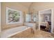 Bathroom with soaking tub, glass shower, and tile flooring at 378 Rhodes House Dr, Suwanee, GA 30024