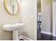Powder room with pedestal sink and wood floors at 378 Rhodes House Dr, Suwanee, GA 30024