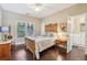Bedroom with queen bed, wood floors, and an en suite bathroom at 378 Rhodes House Dr, Suwanee, GA 30024