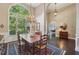 Elegant dining room with large windows and chandelier at 378 Rhodes House Dr, Suwanee, GA 30024