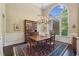 Formal dining room with elegant chandelier and large window at 378 Rhodes House Dr, Suwanee, GA 30024