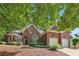 Charming brick home with a two-car garage and lush landscaping at 378 Rhodes House Dr, Suwanee, GA 30024