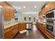 Well-lit kitchen features wood cabinets, stainless appliances, and hardwood floors at 378 Rhodes House Dr, Suwanee, GA 30024