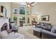 Bright living room with fireplace and large windows overlooking the backyard at 378 Rhodes House Dr, Suwanee, GA 30024