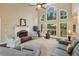 Spacious living room with fireplace and large windows overlooking the backyard at 378 Rhodes House Dr, Suwanee, GA 30024