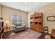 Cozy living room with a large window and comfortable seating area at 378 Rhodes House Dr, Suwanee, GA 30024