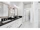 This bathroom features double sinks, white cabinets, and a marble tile shower at 3786 Alstead Manor Way, Suwanee, GA 30024