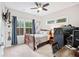 This bedroom includes a ceiling fan, carpeting, and a small desk at 3786 Alstead Manor Way, Suwanee, GA 30024
