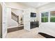 Bright bedroom with staircase view through door, with a modern black dresser, and large window at 3786 Alstead Manor Way, Suwanee, GA 30024