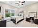Bedroom with large window offering great natural light, complemented by a workstation, and ceiling fan at 3786 Alstead Manor Way, Suwanee, GA 30024