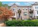 Charming three-story townhome featuring a classic brick facade, landscaped yard, and inviting entrance at 3786 Alstead Manor Way, Suwanee, GA 30024