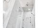 This shower features white marble-style tile and dual rain shower heads at 3786 Alstead Manor Way, Suwanee, GA 30024