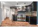 Stylish kitchen with stainless steel appliances, stone backsplash, and dark cabinetry at 3863 Dundee Ne Dr, Roswell, GA 30075
