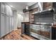Modern kitchen with stainless steel range, stone backsplash, and gray cabinets at 3863 Dundee Ne Dr, Roswell, GA 30075