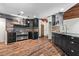 A gourmet kitchen featuring sleek dark cabinets, stainless steel appliances, and stone accents at 3863 Dundee Ne Dr, Roswell, GA 30075