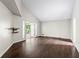 Open living space with vaulted ceilings, wood floors, and outdoor access to a patio at 3863 Dundee Ne Dr, Roswell, GA 30075