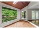 Open living room with wood floors, large window overlooking the lake, skylight and access to the dining area at 3863 Dundee Ne Dr, Roswell, GA 30075