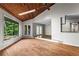 Bright living room with wood floors, skylight, scenic views, opening to the dining room, and French doors at 3863 Dundee Ne Dr, Roswell, GA 30075