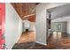 Inviting living room and partial kitchen view featuring wood floors, fireplace, and natural light, as seen from the entry at 3863 Dundee Ne Dr, Roswell, GA 30075