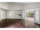 Bright living room with wood floors, access to an outdoor patio, and a vaulted ceiling at 3863 Dundee Ne Dr, Roswell, GA 30075