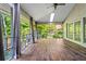 Light-filled sunroom with wood floors and panoramic views of the backyard at 3863 Dundee Ne Dr, Roswell, GA 30075