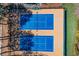 Aerial view of bright blue tennis courts with trees providing shade nearby at 3863 Dundee Ne Dr, Roswell, GA 30075