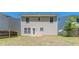 This backyard features a grassy area and a two story home at 5280 Tussahaw Xing, Mcdonough, GA 30252