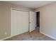 Bedroom features a closet with bi-fold doors and a doorway to the hall at 5280 Tussahaw Xing, Mcdonough, GA 30252