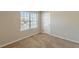 This bedroom has neutral walls and carpet with a window letting in lots of light at 5280 Tussahaw Xing, Mcdonough, GA 30252