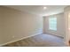 Bedroom with a window and neutral carpet and paint at 5280 Tussahaw Xing, Mcdonough, GA 30252