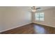 Cozy bedroom featuring wood-look floors, a window with blinds, and neutral wall paint at 5280 Tussahaw Xing, Mcdonough, GA 30252