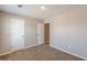 This bedroom features neutral walls, carpet and white doors at 5280 Tussahaw Xing, Mcdonough, GA 30252