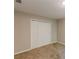 Carpeted bedroom features a closet with bi-fold doors at 5280 Tussahaw Xing, Mcdonough, GA 30252