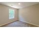 Bedroom with a large window and neutral carpet and paint at 5280 Tussahaw Xing, Mcdonough, GA 30252