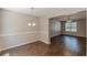 Open-concept dining room features modern lighting and hardwood floors at 5280 Tussahaw Xing, Mcdonough, GA 30252