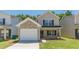 Charming two-story home featuring a brick and vinyl exterior, attached garage, and well-maintained front lawn at 5280 Tussahaw Xing, Mcdonough, GA 30252