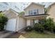 Two-story home featuring neutral siding, brick accents, an attached garage, and neatly trimmed landscaping at 5280 Tussahaw Xing, Mcdonough, GA 30252