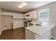 Bright kitchen features white cabinets, stainless steel appliances, and quartz countertops at 5280 Tussahaw Xing, Mcdonough, GA 30252