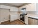 Clean kitchen with stainless appliances, white cabinets, and durable floors at 5280 Tussahaw Xing, Mcdonough, GA 30252