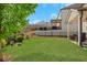 Spacious backyard featuring a patio, lush green lawn, and secure black metal fence, perfect for outdoor enjoyment at 5751 Green Arbor Way, Sugar Hill, GA 30518