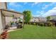Large, well-maintained backyard with lawn, patio seating, and view of neighboring homes at 5751 Green Arbor Way, Sugar Hill, GA 30518
