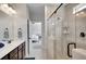 Primary bathroom featuring a glass shower, double sink vanity, tile floors and view to the bedroom at 5751 Green Arbor Way, Sugar Hill, GA 30518