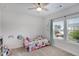 Bright bedroom with large window, plush carpet, a colorful bed and plenty of natural light at 5751 Green Arbor Way, Sugar Hill, GA 30518